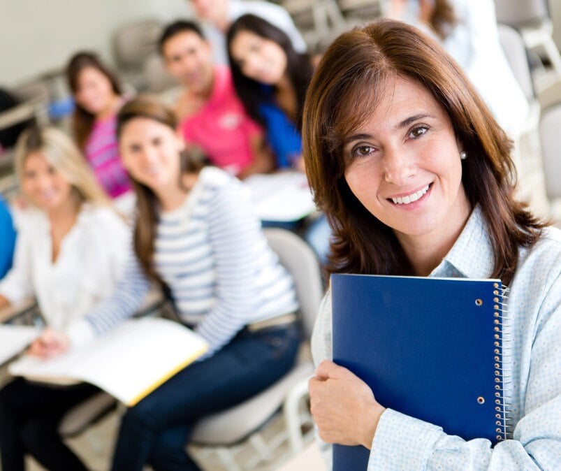 Older female student in class holding a notebook-1